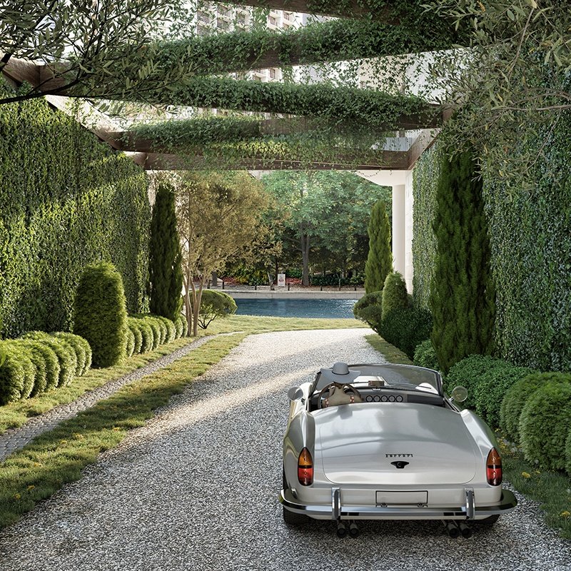 Vintage silver convertible on gravel driveway with pool and trees