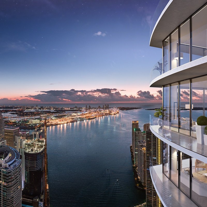 City skyline and river at sunset from modern high-rise balcony