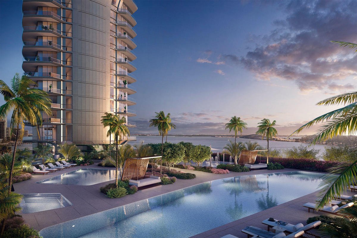 Luxury apartment building overlooking waterfront with swimming pool
