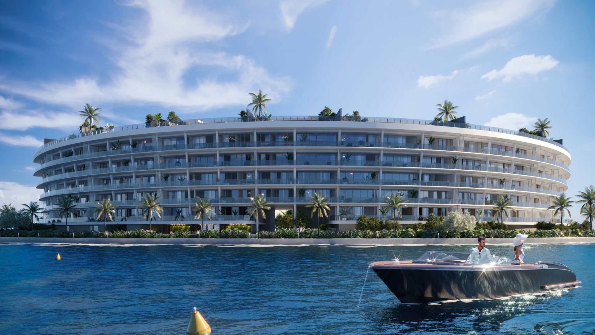 Luxury waterfront hotel with curved architecture, palm trees, and boat
